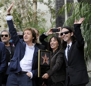 Former Beatle Paul McCartney, left, poses with George Harrison's widow Olivia, center, and Harrison's son Dhani during a posthumous Hollywood Walk of Fame star dedication for the late Beatle in Los Angeles, Tuesday, April 14, 2009. 