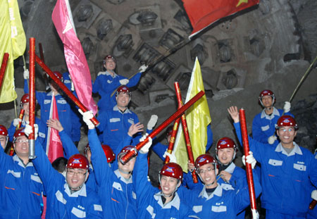 Workers celebrate after the world's longest water diversion tunnel is completed in northeast China's Liaoning Province, on April 15, 2009. 