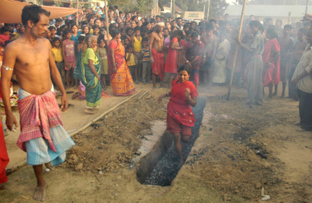  A Hindu devotee walks over burning coals during the annual 'Shiva Gajan' religious festival in Pratapgarh, about 30 km (19 miles) from Agartala, capital of India's northeastern state of Tripura, April 14, 2009. Hundreds of faithful devotees offer sacrifices and perform acts of devotions during the festival in the hopes of winning the favour of Hindu god Shiva and ensure the fulfilment of their wishes and also to mark the Bengali year-end. [Xinhua/Reuters]