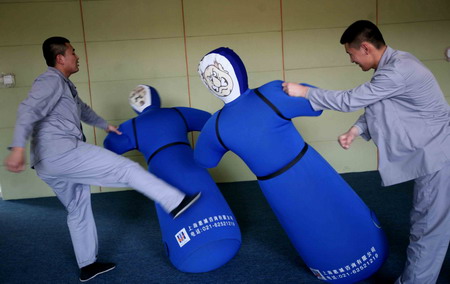 Patients hit and kick gas-filled dummies to relieve pressure during a treatment process inside Tiantanghe compulsory rehabilitation center in Beijing, April 13, 2009. [CFP]