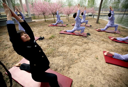 A policewoman teaches female patients a yoga class during a treatment process inside Tiantanghe compulsory rehabilitation center in Beijing, April 13, 2009. [CFP]