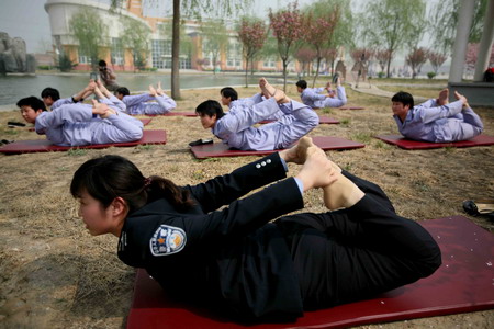 A policewoman teaches female patients a yoga class during a treatment process inside Tiantanghe compulsory rehabilitation center in Beijing, April 13, 2009. [CFP]