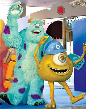 Monsters, Inc. characters Sally (left) and Mike celebrate the opening of 'Monsters, Inc. Ride and Go Seek' at Tokyo Disneyland yesterday. 