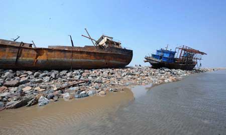 Photo taken on April 16, 2009 shows two dredgers lie on the beach after being badly damaged during a gale off north China's Tianjin Municipality. Three crew members were confirmed dead and six others were missing during the accident. (Xinhua/Liu Haifeng)