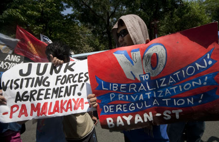 Protesters holding placards against the Philippines-US Visiting Forces Agreement (VFA) march to the U.S. Embassy in Manila, the Philippines, on April 16, 2009. Protesters called for the abolition of the VFA, which allows the presence of US troops in the country to conduct military exercises with Filipino counterparts in various Philippine provinces.[Xinhua]