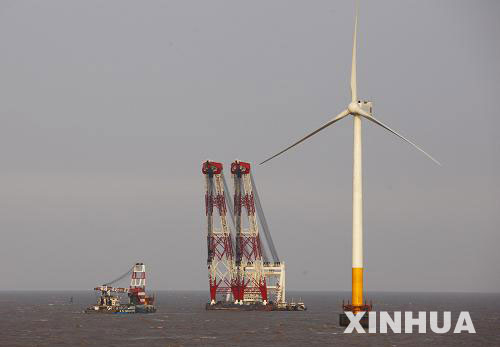 Photo taken on April 1, 2009 shows one of the three 92-meter-high turbines standing just a few kilometers from the Shanghai East China Sea Bridge. The remaining 31 turbines will be constructed in the near future. 