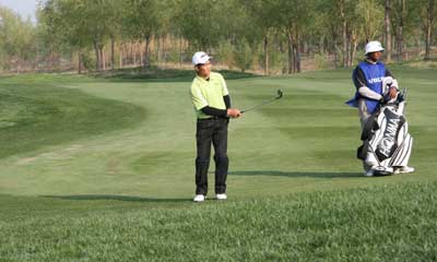 No need to grimace - Liang Wenchong holed this 50-foot chip for birdie at 17. 