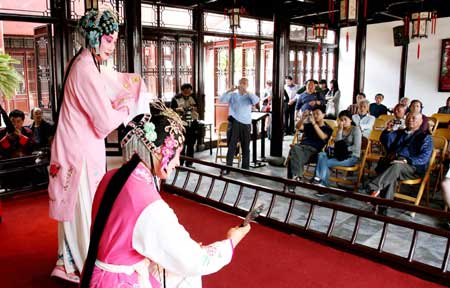 Actresses perform a repertoire of Kun Opera in the Lingering Garden in Suzhou City, east China&apos;s Jiangsu Province, April 15, 2009. A special tourism promoting activity featuring the Wu culture and Wu music kicked off in the Lingering Garden on Thursday. Dozens of actors will perform traditional Wu music such as Kun Opera and Pingtan to entertain tourists while they enjoy the garden sceneries. (Xinhua Photo) 
