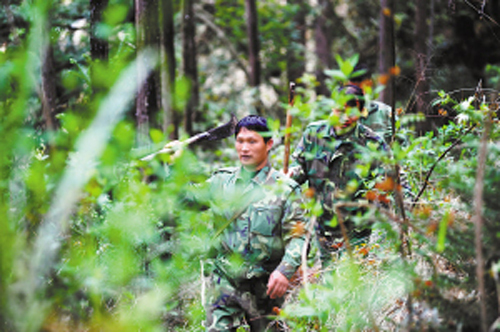 Forestry worker Kan Chunjiang and his team are on patrol duty. Kan has been working as a forestry worker in the Yusi Mountain, Xiajiang County of Jiangxi Province, for more than 20 years. Thanks to his painstaking effort, there are no forest fires in the area over the past decades. [Photo from Jiangxi Daily published on April 6, 2009]