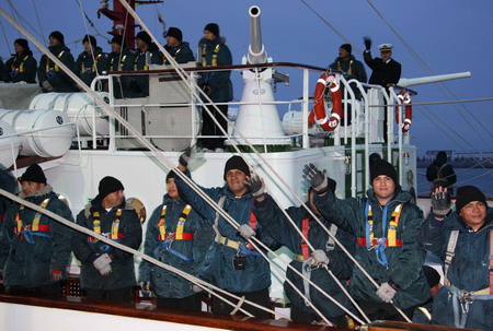 Mexican naval soldiers wave their hands on their military ship upon its arrival at the Qingdao port in east China's Shandong province, April 18, 2009.