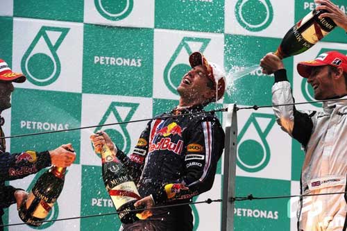 Red Bull driver Sebastian Vettel (C) of Germany, Australian Mark Webber (L) and Brawn GP's Jenson Button spray champagne at the victory ceremony of the Chinese F1 Grand Prix in Shanghai, east China, April 19, 2009. 