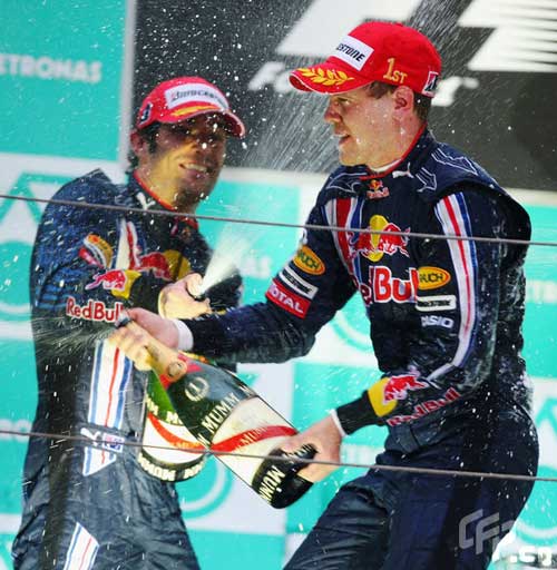 Red Bull driver Sebastian Vettel (R) of Germany, Australian Mark Webber spray champagne at the victory ceremony of the Chinese F1 Grand Prix in Shanghai, east China, April 19, 2009. [CFP] 