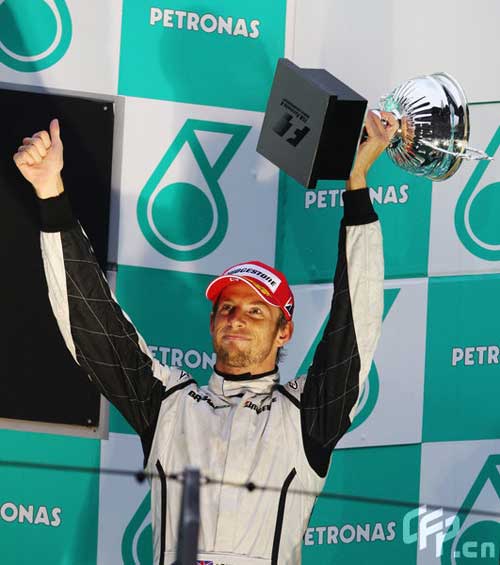 Brawn GP's Jenson Button celebtates at the victory ceremony of the Chinese F1 Grand Prix in Shanghai, east China, April 19, 2009. [CFP]