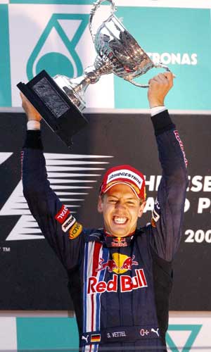  Red Bull driver Sebastian Vettel of Germany celebrates with his trophy after winning the Chinese F1 Grand Prix in Shanghai, east China, April 19, 2009. Vettel won with 1 hour 57 minutes and 43.485 seconds.[Xinhua]