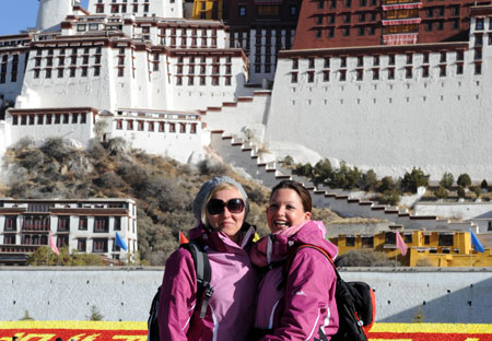 German tourists pose for a photo in front of the Potala Palace in Lhasa, capital of southwest China's Tibet Autonomous Region, April 5, 2009. One out of ten visitors to Tibet is from a foreign country after the region reopened to foreign tourists or tourists from China's Hong Kong, Macao and Taiwan in early April. [Xinhua/Chogo] 