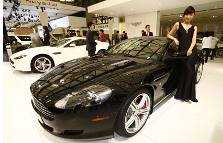 A model displays an Aston Martin sports car at the Shanghai auto expo in Shanghai, east China, April 20, 2009. 