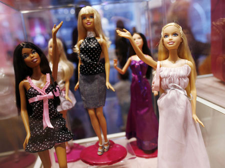 Barbie dolls are seen inside the FAO Schwartz toy store in New York, March 9, 2009. Barbie, the iconic doll that has claimed countless hours of girls' lives in a make-believe world that mirrored real life glamour, high-fashion and fabulous careers, is turning 50.[Xinhua/Reuters]