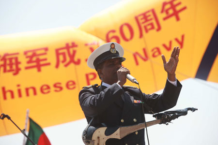 A member of Bangladeshi navy's military band sings during a performance in Qingdao, east China's Shandong Province, April 21, 2009.[Li Gang/Xinhua]