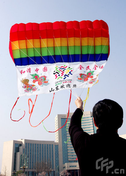 Team members fly a kite at the 26th Weifang International Kite Festival on April 21, 2009 in Weifang of Shandong Province, China. Weifang, the birth place of kites, holds the international kite festival every year in spring since 1984, attracting competitors and tourists worldwide. [Photo by Wang Zhide/ChinaFotoPress] 