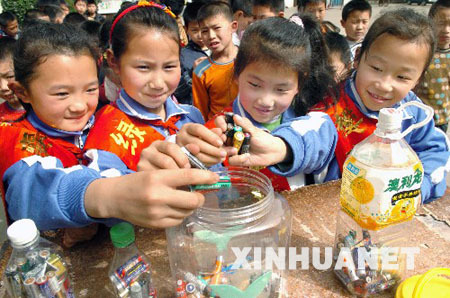 Students collect old used batteries in the Shenzhou School, Xiangfan City of Hubei Province, on April 20, 2009. The Earth Day, celebrated on every April 22, is a day designed to inspire people&apos;s awareness and appreciation for the Earth&apos;s environment.