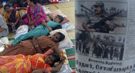 Members of the Women against Eelam Tamil Genocide group rest next to a newspaper photograph of the LTTE leader Vellupillai Prabhakaran, on what they say is the 10th consecutive day of their fast-unto-death silent protest in the southern Indian city of Chennai April 22, 2009.