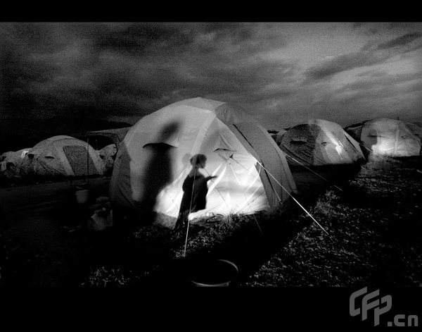 Shadows of children dance across the tents of this small tent city just outside of Cabaret, Haiti, October 22, 2008. The tents served as a temporary shelter for these many families left homeless after Hurricane Ike ravaged this small town.[CFP]