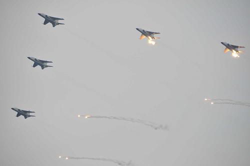 Military aircrafts are seen during a naval parade of the Chinese People's Liberation Army (PLA) Navy warships and aircraft in waters off China's port city of Qingdao, east China's Shandong Province, on April 23, 2009. [Li Gang/Xinhua]