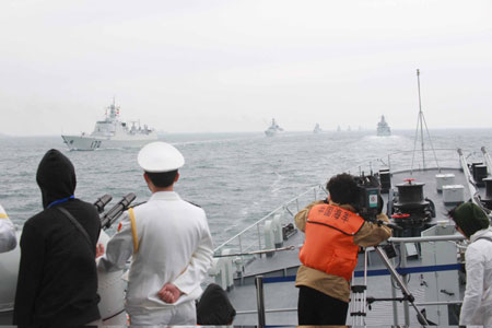 A naval parade of the Chinese People's Liberation Army (PLA) Navy warships and aircraft is held in waters off China's port city of Qingdao, east China's Shandong Province, on April 23, 2009. [Li Gang/Xinhua]