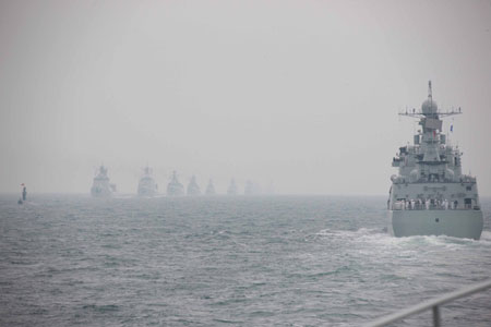 A naval parade of the Chinese People's Liberation Army (PLA) Navy warships and aircraft is held in waters off China's port city of Qingdao, east China's Shandong Province, on April 23, 2009. [Li Gang/Xinhua]