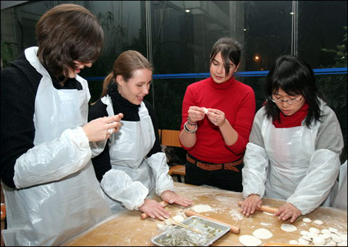 In this file photo foreign students studying in the Shanghai Fudan University learn to make traditional Chinese food dumplings. 