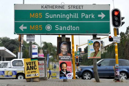 Vehicles run by posters of presidential candidates in Johannesburg, April 21, 2009. South Africa will hold the general elections on Wednesday. More than 3 million votes had been counted in South Africa's national elections by 8:30 a.m. on Thursday morning which showed that the ruling party African National Congress (ANC) takes lead in the polls. [Xu Suhui/Xinhua]