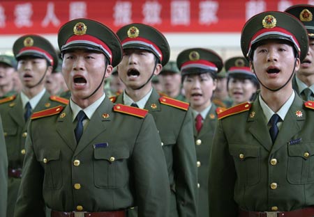 Uniformed Chinese students from Tianjin University of Science and Technology join in a chorus at a commemorative ceremony in north China's coastal city of Tianjin, April 22, 2009. The university has been joining hands with Beijing Military Area Command of the Chinese People's Liberation Army (PLA) for five years to educate high-quality national defense officers for the PLA. [Li Xiang/Xinhua]