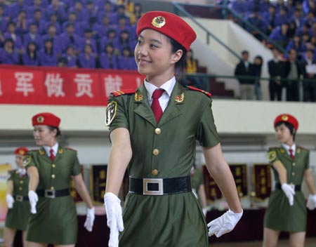 Uniformed Chinese girl students from Tianjin University of Science and Technology join in a group performance at a commemorative ceremony in north China's coastal city of Tianjin, April 22, 2009. The university has been joining hands with Beijing Military Area Command of the Chinese People's Liberation Army (PLA) for five years to educate high-quality national defense officers for the PLA. [Li Xiang/Xinhua] 