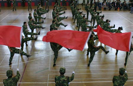 Chinese students from Tianjin University of Science and Technology stage combat skills at a commemorative ceremony in north China's coastal city of Tianjin, April 22, 2009. The university has been joining hands with Beijing Military Area Command of the Chinese People's Liberation Army (PLA) for five years to educate high-quality national defense officers for the PLA. [Li Xiang/Xinhua] 