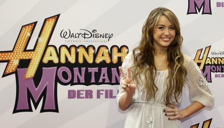 U.S. actress Miley Cyrus gestures while arriving for the German film premiere &apos;Hannah Montana-The Movie&apos; in Munich April 25, 2009.