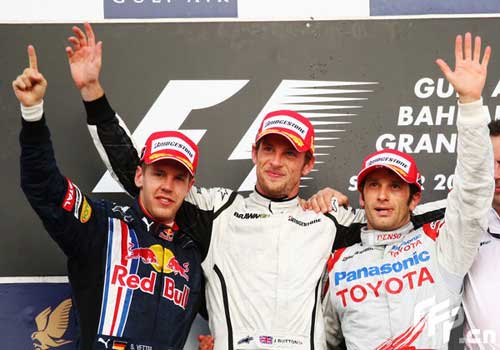 Race winner Jenson Button (C) of Great Britain and Brawn GP, second placed Sebastian Vettel (L) of Germany and Red Bull Racing and third placed Jarno Trulli (R) of Italy and Toyota celebrate on the podium following the Bahrain Formula One Grand Prix at the Bahrain International Circuit on April 26, 2009 in Sakhir, Bahrain. [CFP]