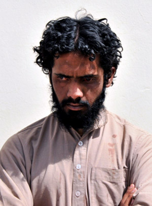 One of the seven arrested Taliban members stands in front of a wall in Helmand province, southern Afghanistan, April 25, 2009. Afghan security force has arrested seven Taliban militants during an operation in southern troubled province of Afghanistan.