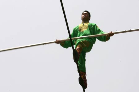 Dawaz performer Samit Ijon walks on the wire in the Tianmen Mountain in Zhangjiajie, central-south China's Hunan Province, April 25, 2009. He succeeded in finishing the walk on the over 700-meter-long and 300-meter-high wire with a gradient as steep as over 39 degrees.