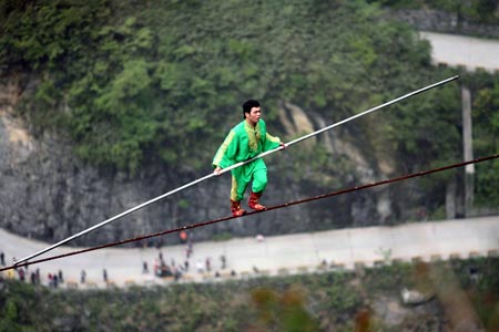 Dawaz performer Samit Ijon walks on the wire in the Tianmen Mountain in Zhangjiajie, central-south China's Hunan Province, April 25, 2009.