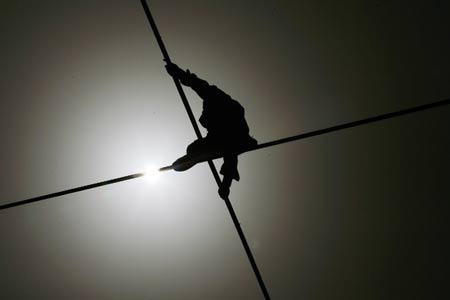 Dawaz performer Samit Ijon walks on the wire in the Tianmen Mountain in Zhangjiajie, central-south China's Hunan Province, April 25, 2009.