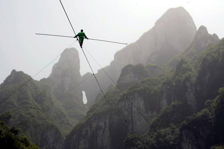 Dawaz performer Samit Ijon walks on the wire in the Tianmen Mountain in Zhangjiajie, central-south China's Hunan Province, April 25, 2009. 