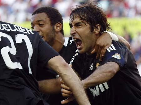 Real Madrid's Raul Gonzalez from Spain (R) reacts after scoring with teammates during their La Liga soccer match against Sevilla at the Ramon Sanchez Pizjuan stadium in Sevilla, Sunday, April 26, 2009.
