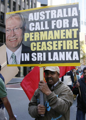 An ethnic Tamil demonstrator holds a banner with a picture of Australia's Prime Minister Kevin Rudd during a protest against Sri Lanka government in central Sydney April 26, 2009.