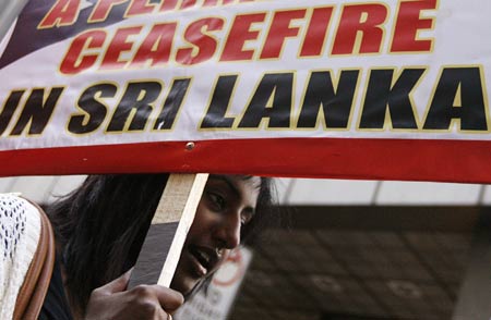 An ethnic Tamil demonstrator holds a banner during a protest against Sri Lanka government in central Sydney April 26, 2009. The protesters demanded the Australian government to pressure the Sri Lankan state into entering an immediate and permanent cease fire.