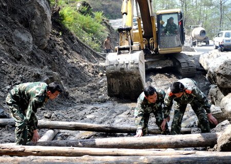 Members of the Chinese People's Armed Police Force work at the construction site of the Lhasa-Kathmandu Highway in southwest China's Tibet Autonomous Region, April 6, 2009. The 800-kilometer Chinese section of the 900-kilometer Lhasa-Kathmandu Highway is under reconstruction, which is expected to be finished in September 2009. The highway begins in Lhasa, capital of southwest China's Tibet Autonomous Region, and ends in Kathmandu, capital of Nepal.