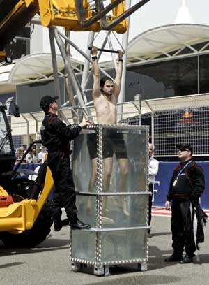 David Merlini prepares to submerge into a crystal watertank in Manama, capital of Bahrain, April 26, 2009.