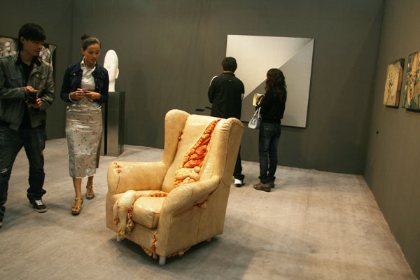 Visitors appreciate art pieces presented by Pifo New Art Gallery at the 2009 Art Beijing Contemporary Art Fair on April 27, 2009.