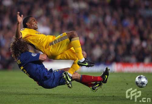 Barcelona's Carles Puyol (left) challenges Chelsea's Florent Malouda.