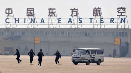 Policemen rush to the "hijacked" plane in the anti-hijacking exercise held at Tianhe Airport in Wuhan, capital of central China