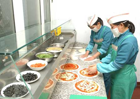 Chefs prepare pizza at the first Italian restaurant in Pyongyang, capital of the Democratic People's Republic of Korea (DPRK), in this picture released by Korean Central News Agency (KCNA) on April 28, 2009. 